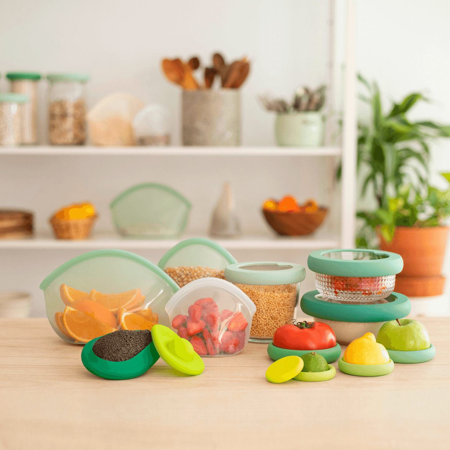 Set of thirteen green sustainable and eco-friendly food exchanges that keep food fresh, snacks and leftovers on a wooden table