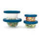 Two glass bowls, one on top of the other, next to two, with adjustable and sustainable blue silicone lids to preserve food