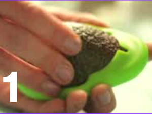 Step one person pulling an avocado into an avocado hugger.