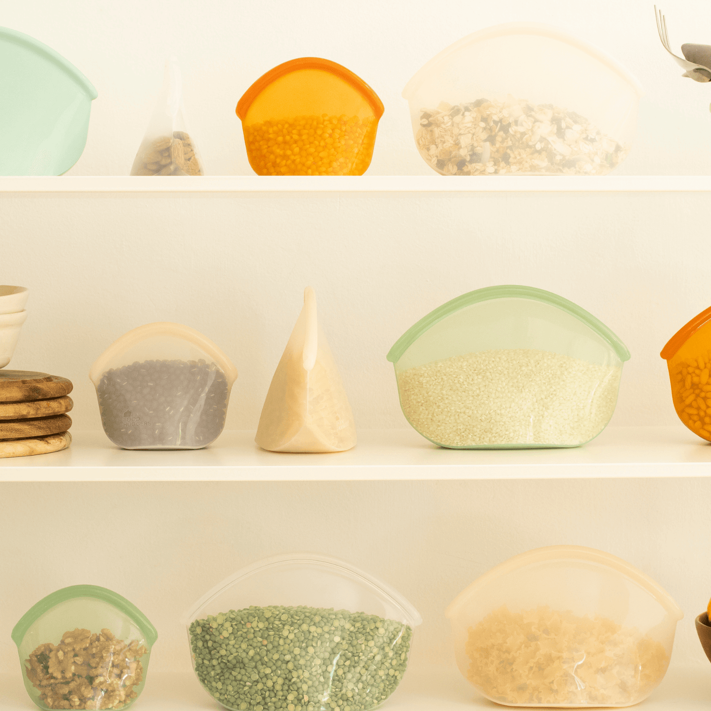 "White three-part shelf with reusable silicone bags as an alternative to plastic waste, filled with beans"