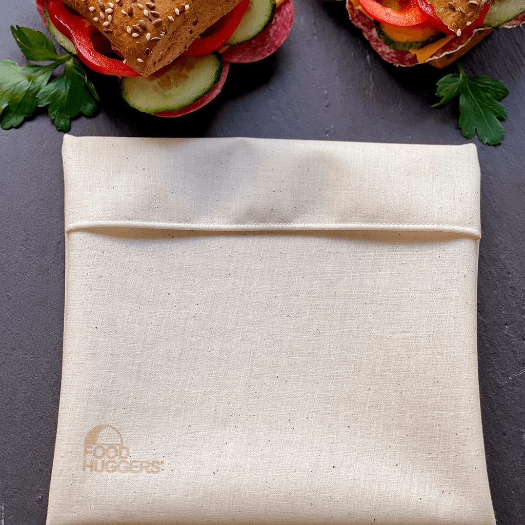 A reusable Food Huggers Fabric Bag and two sandwiches