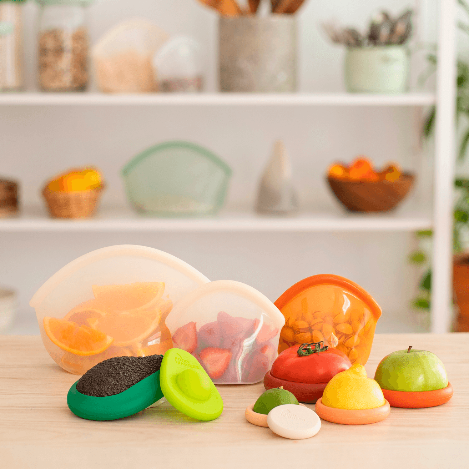 Set of ten silicone orange Food Huggers protecting fruits and vegetables on a wooden table