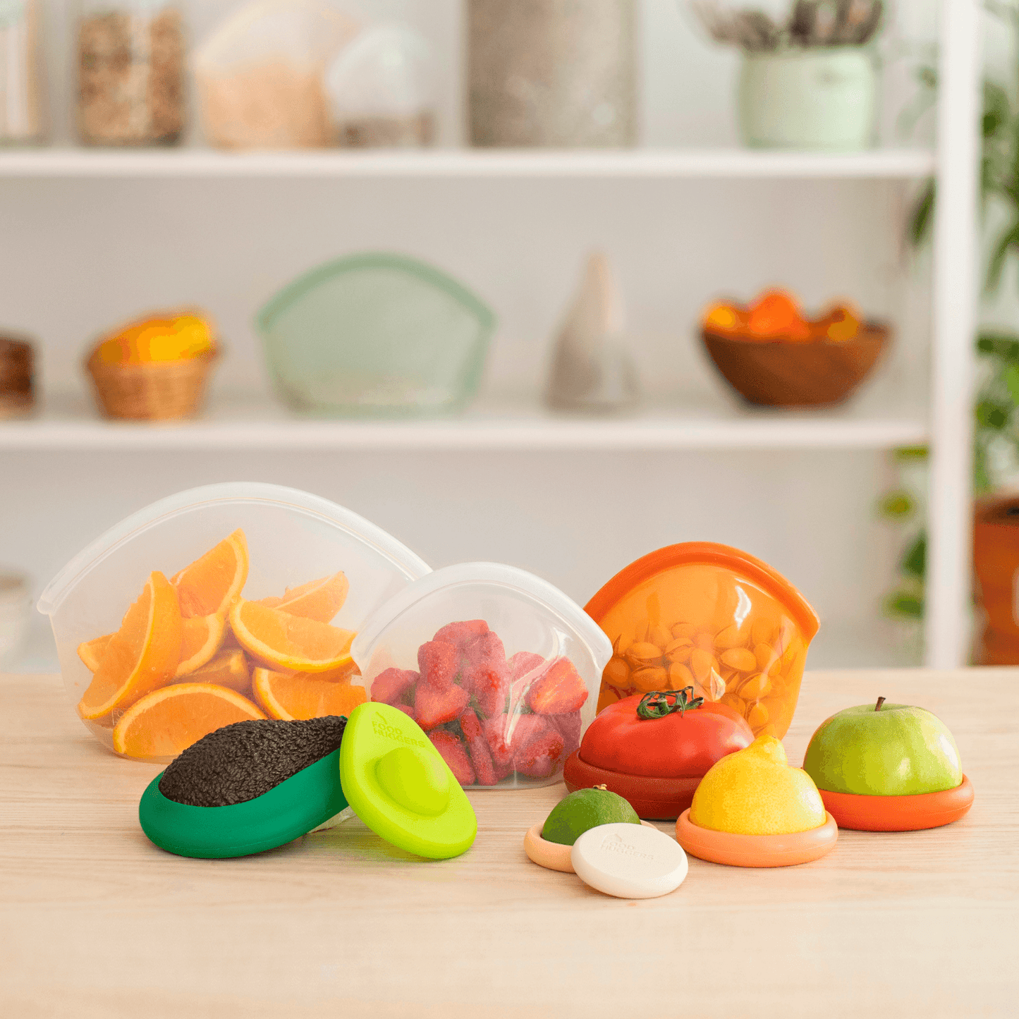 Set of ten silicone orange and white Food Huggers protecting fruits and vegetables on a wooden table