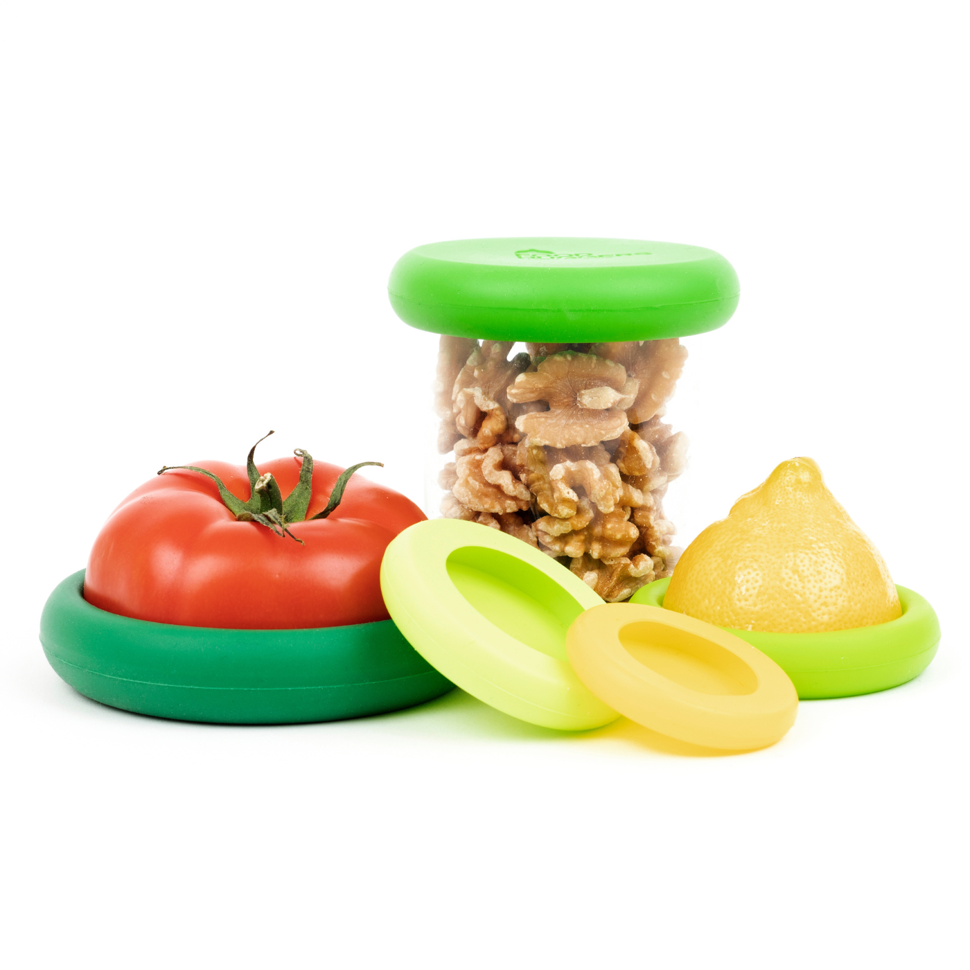 Set of five green sustainable Food Huggers that seal and preserve a tomato, and also a replacement lid for jars