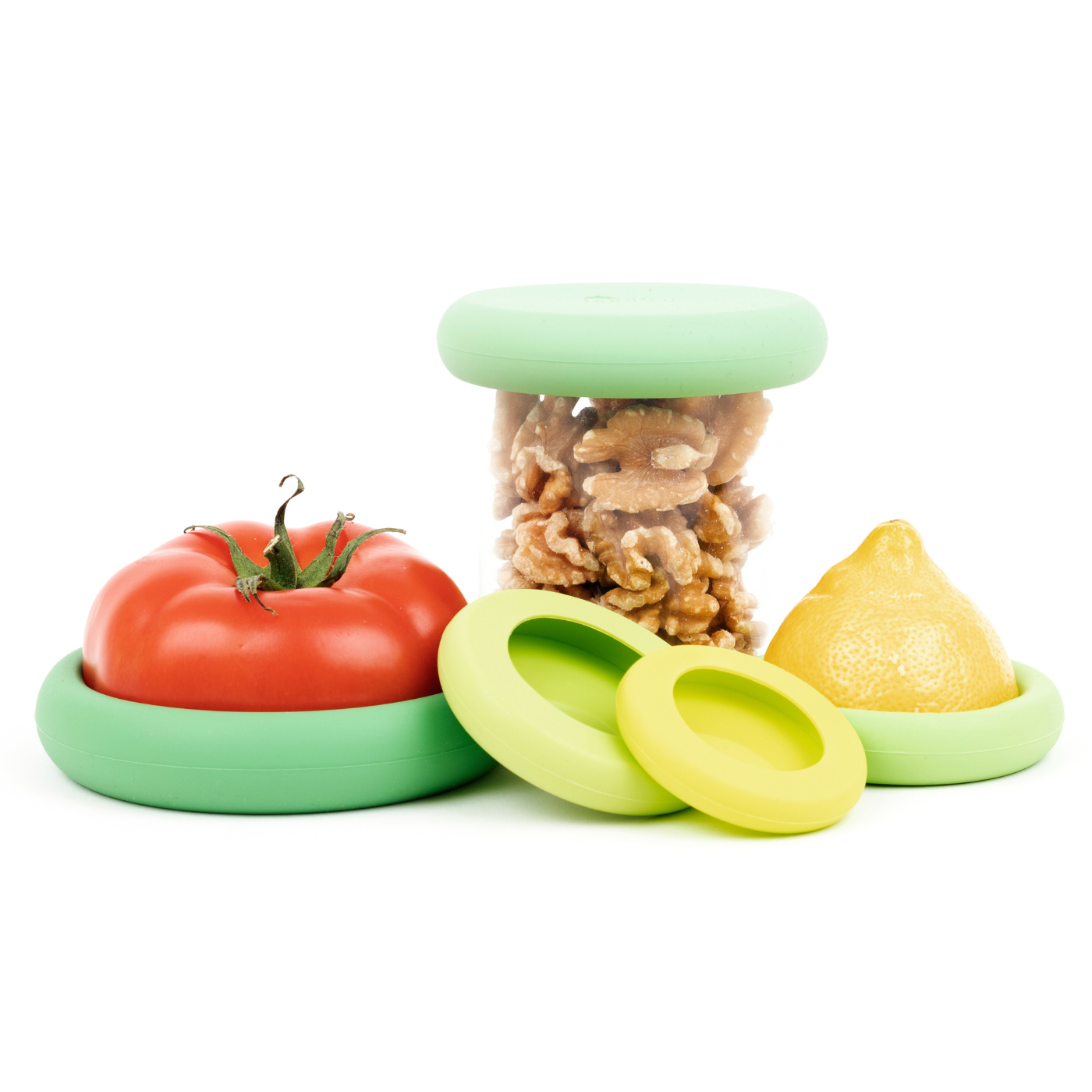 Set of five green sustainable Food Huggers that seal and preserve a tomato, and also a replacement lid for jars