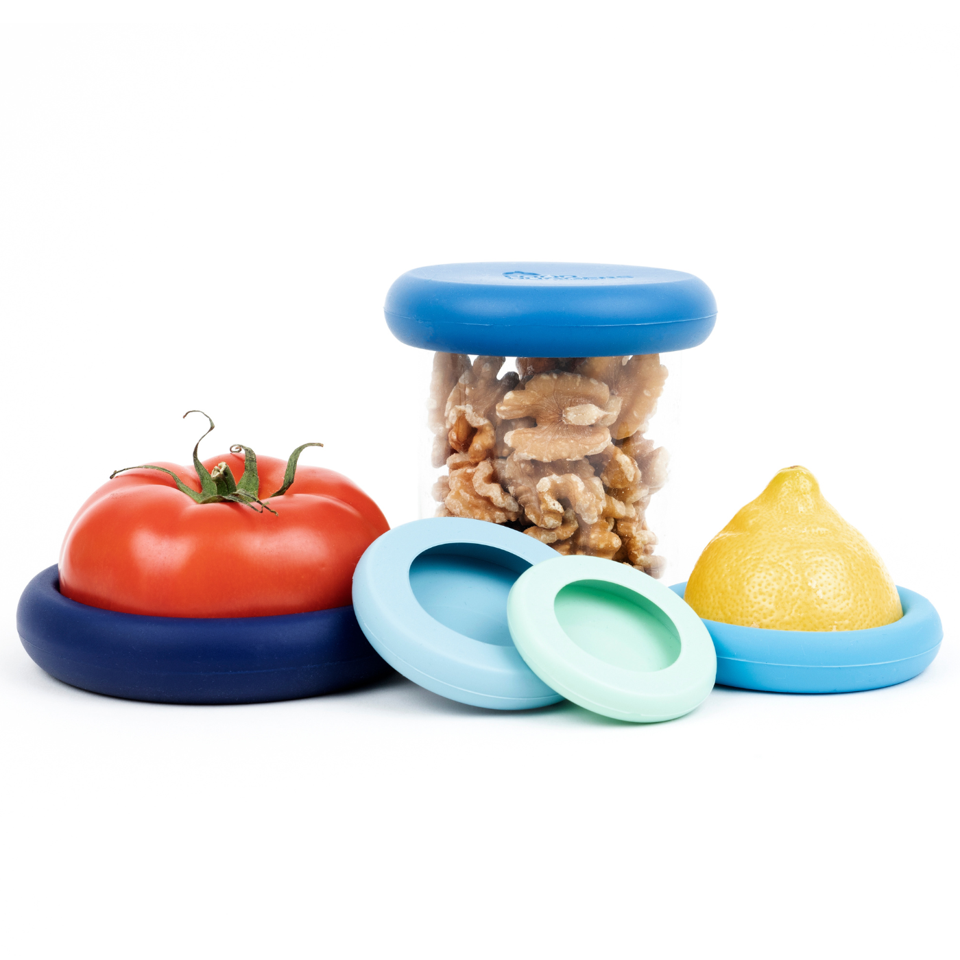 Set of five blue sustainable Food Huggers that seal and preserve a tomato, and also a replacement lid for jars