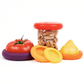 Set of five red and orange sustainable Food Huggers that seal and preserve a tomato, and also a replacement lid for jars