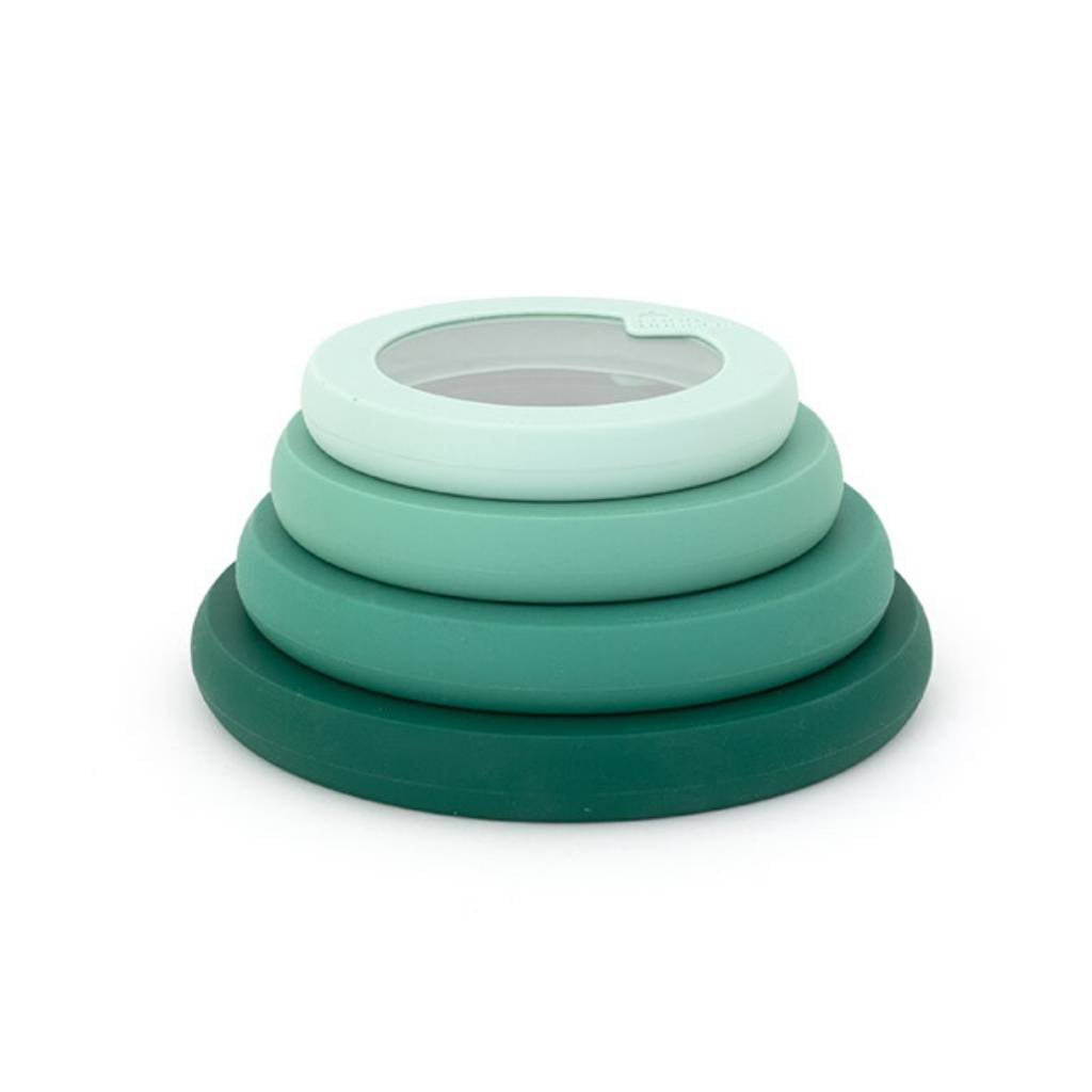 Green Food Huggers lids of different sizes one on top of the other arranged in one tower