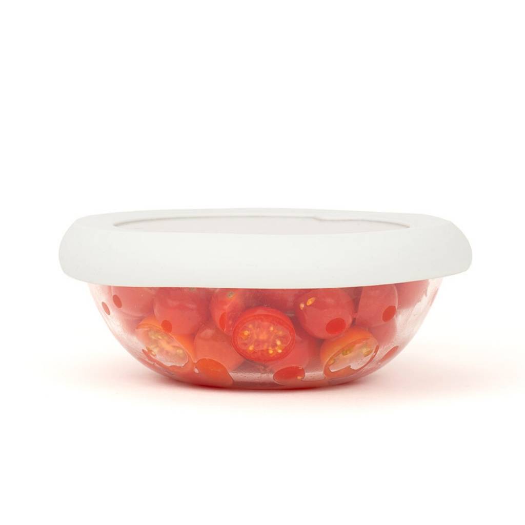 Glass bowl filled with tomatoes with white sustainable hugger lid for preserving food