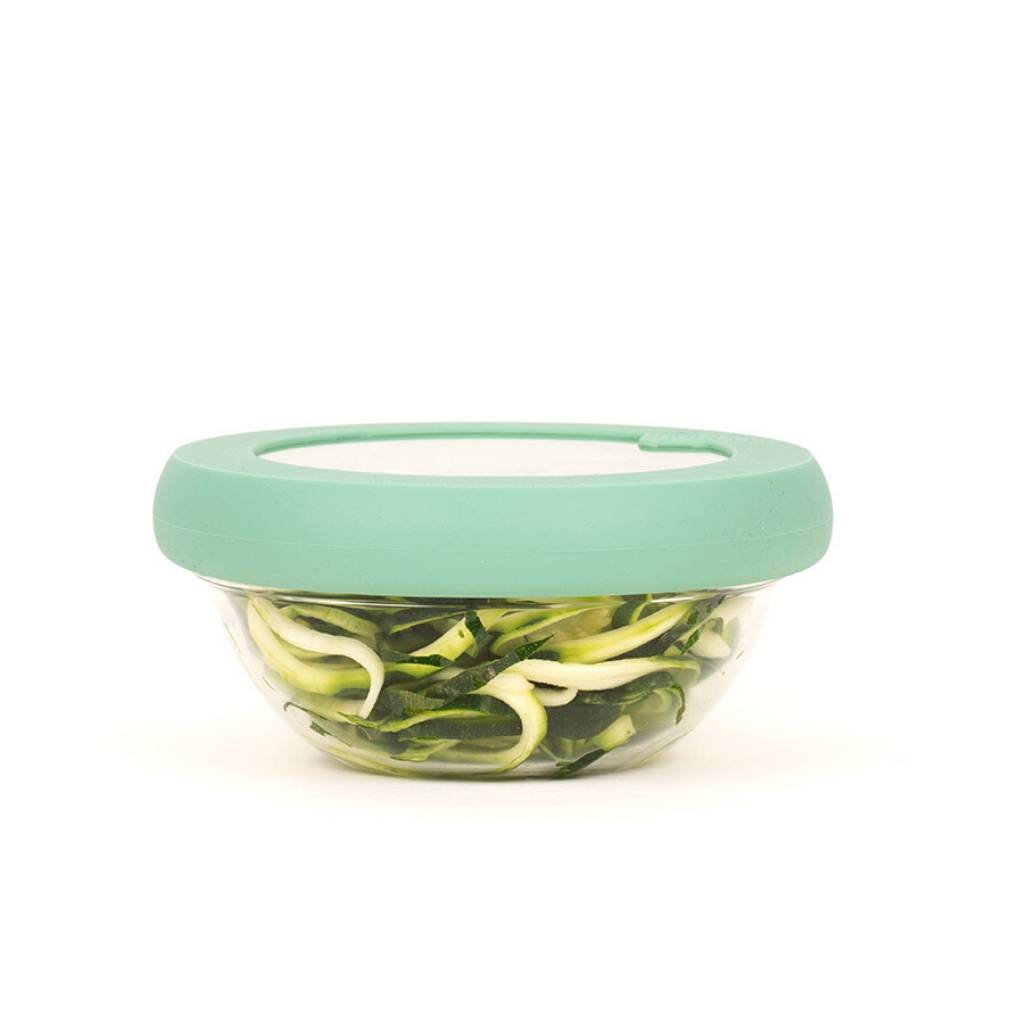 Glass bowl filled with vegetables with sustainable green hugger lids for preserving food