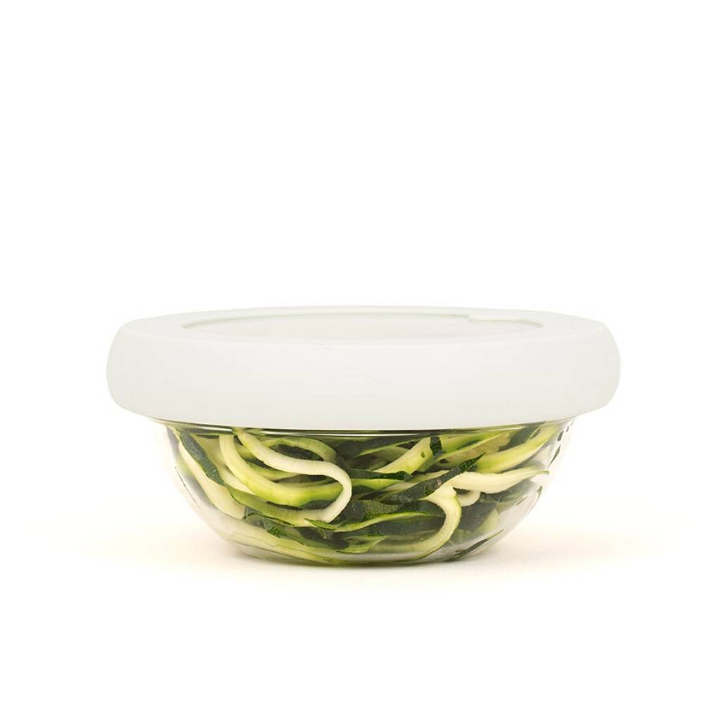 Glass bowl filled with vegetables with sustainable white hugger lids for preserving food
